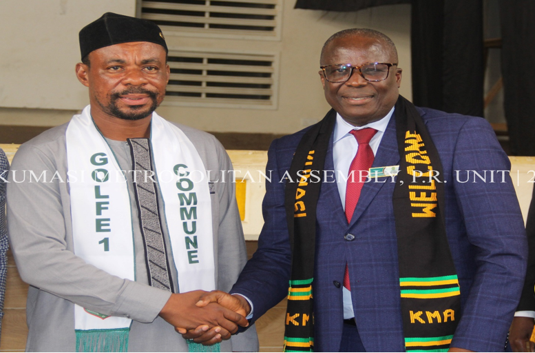 Hon. Patrick Frimpong -PM in a handshake with the Golfe 1 mayor during the General Assembly Meeting