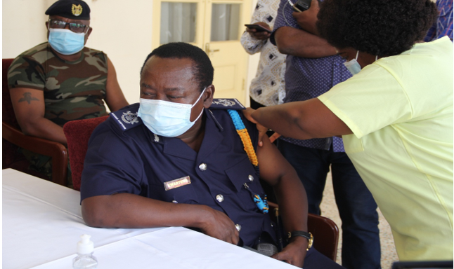 A CUSTOMS OFFICER TAKING THE ASTRAZENECA VACCINE JAB